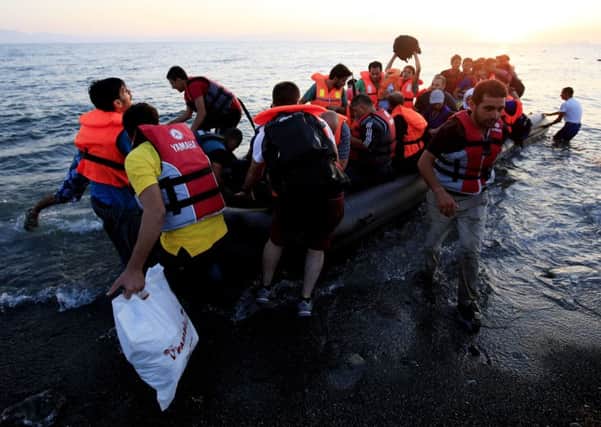 A group of refugees in a rubber dinghy arriving on the beach at Psalidi near Kos Town, Kos, Greece this summer.