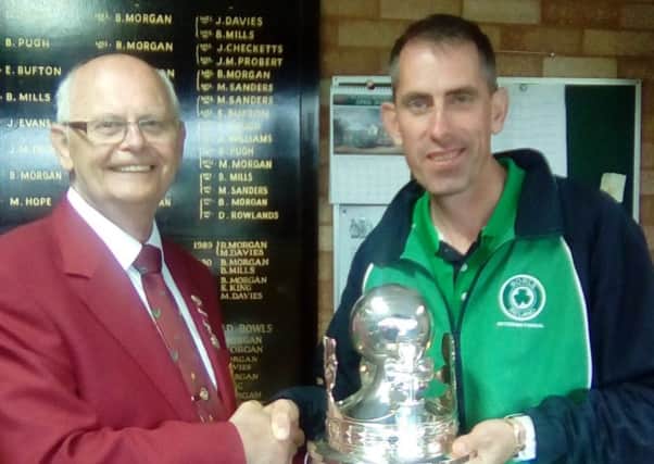 Martin McHugh receives the British Singles trophy from British Isles Bowls Council President Jim Humphreys. INLT 27-926-CON