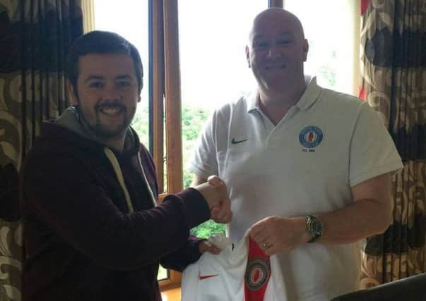 Nathan Baird is welcomed to Banbridge Rangers by club chairman John Patterson.