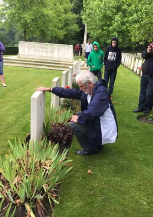 Garfield Gracey visiting the grave of his relative in France.