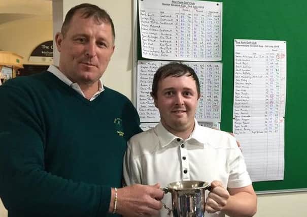 Dee McKenna (right) winner of the 2016 Scratch Cup at Roe Park being presented the trophy by Roe Park Captain and sponsor, Seamus McConalogue.