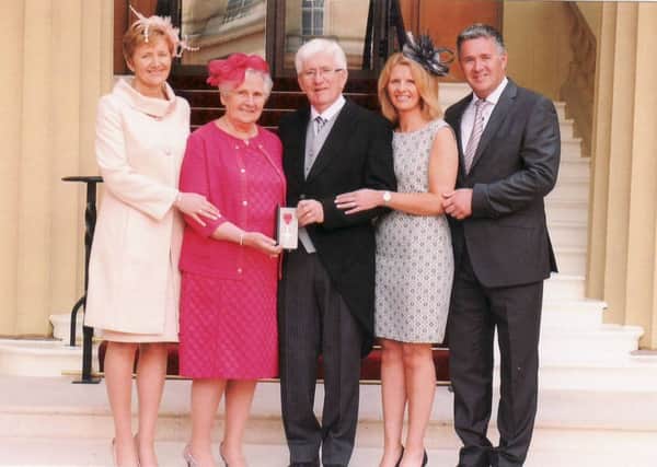 Alan Little pictured receiving his MBE alongside (l-r) his daughter Elaine Knox, wife Hazel, daughter Beth McKeown, and son Ian.
