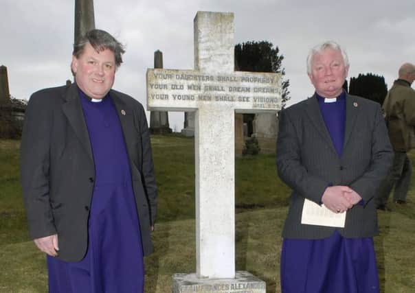 Dean William Morton and Canon John Merrick at Cecil Frances Alexander's grave in Londonderry. Cecil's daughter Eleanor wrote an ode to those who died at the Somme.