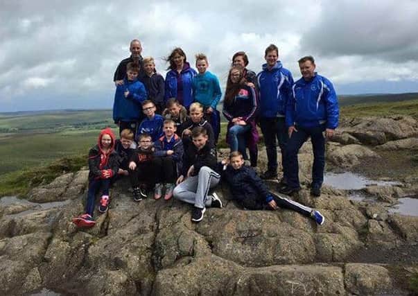 Northend United U11 players, coaches  and parents on their sponsored climb of Slemish to raise funds for their entry in the Foyle Cup.