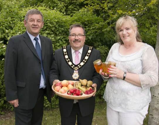Mayor of Antrim and Newtownabbey, Councillor John Scott, John Kerr, Six Mile Water Trust and Susie Hill, Ulster Beekeepers Association admire some of the food products that depend on pollination for growth.