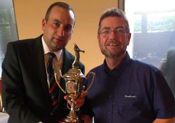 Captain Stephen Gardiner presents the captain's prize to Des Callaghan, overall winner with 37pts. INLT 27-922-CON