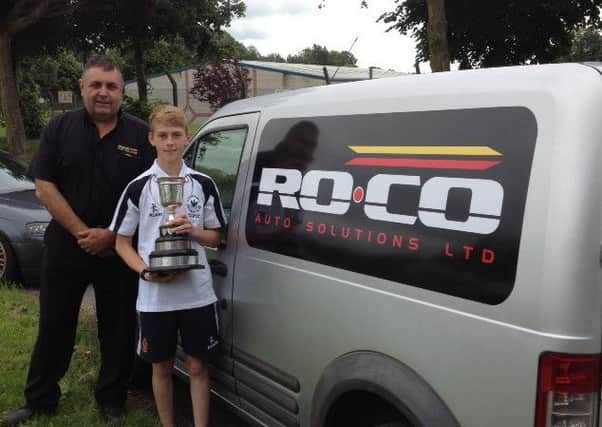 Colin Rainey from Ro-Co congratulated Jonny Lynch the team captain, pictured here holding the cup, on their fine victory.
