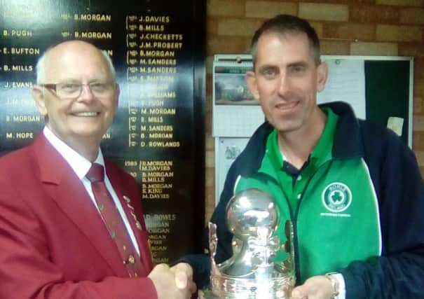 Martin McHugh receives the British Singles trophy from British Isles Bowls Council President Jim Humphreys. INLT 27-926-CON