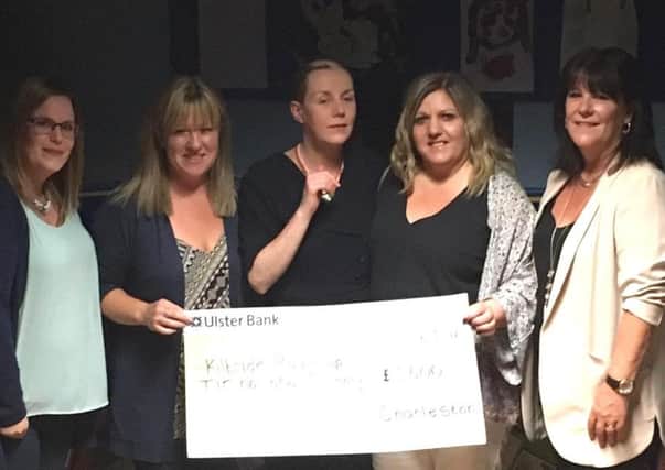 Mary Hurst (centre) is pictured presenting a cheque to representatives from Tir na nOg Primary School and Kilbride Playgroup. INNT 28-800CON