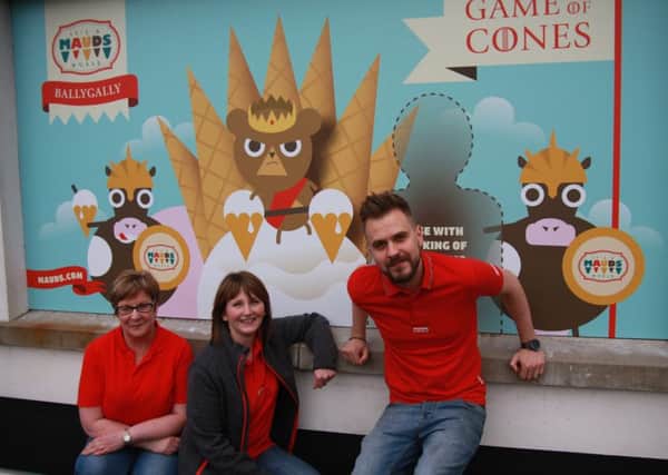 Artist and graphic designer Christopher Todd poses with colleagues beside the Game of Thrones-themed mural he created outside Ballygally Spar. INLT-27-708-con