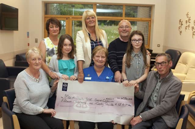 BIG CHEQUE. Deputy Ward Sister at the Macmillan Unit at Antrim Area Hospital, Bernadette McWilliams, pictured on Thursday evening receiving a cheque for the magnificant sum of Â£15.020.00 from parents of the late Clifford Kerr, James Albert and Anne. The money was raised at a Tractor Run in memory of Albert which took part from the Scenic Inn. Looking on are Christine (sister of Clifford) and Andrew Christie, Shirley McKinley, (owner of the Scenic Inn) and Shannon and Tiffany.INBM27-16 001SC.