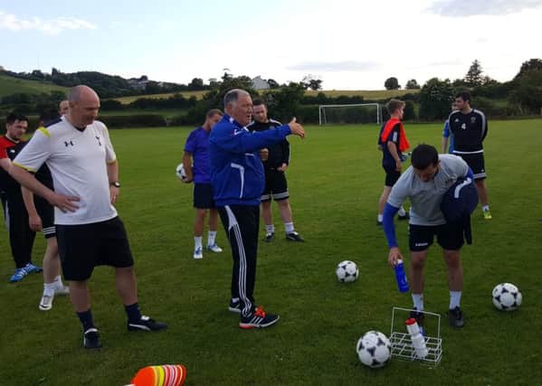 Paul Kirk talking to players at training after Tuesday evening`s session.