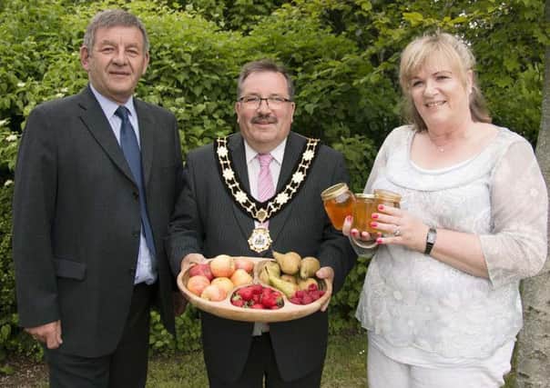 Mayor John Scott, John Kerr, Six Mile Water Trust and Susie Hill, Ulster Beekeepers Association admire some of the food products that depend on pollination for growth. INNT 28-510CON