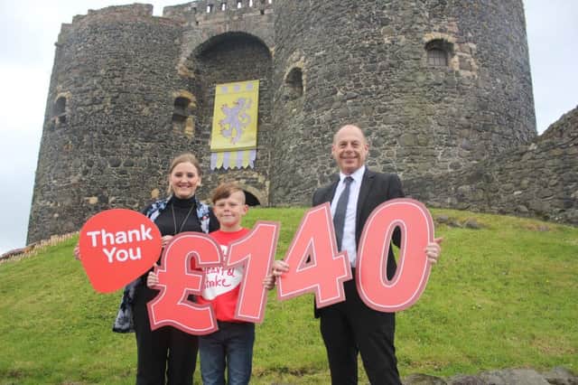 Alistair Patterson, Mace Regional manager, with his son Adam, and Victoria Ross, Corporate Fundraising officer for NI Chest Heart & Stroke. INCT 28-707-CON