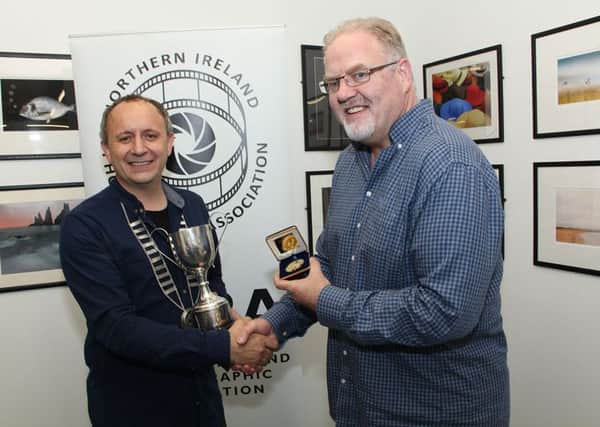 NIPA President Vittorio Silvestri left presents Lisburn's Ross McKelvey from Catchlight Camera Club with his NIPA award.