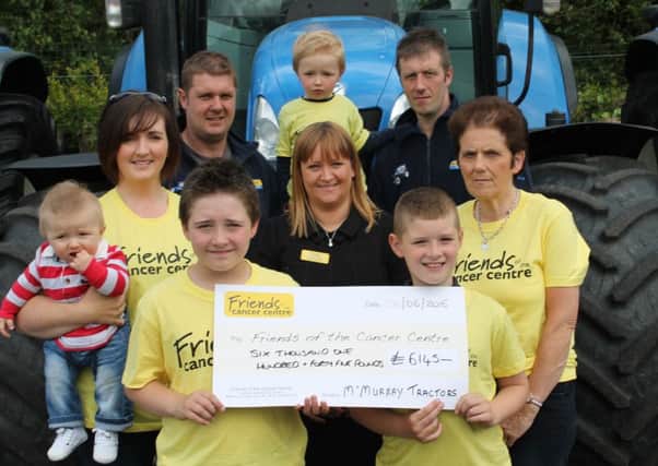 The McMurray family with a cheque for Friends of the Cancer Centre after raising Â£6,145.08 in memory of the late Ivan McMurray with a tractor run and barbecue.