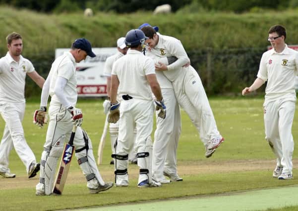 Fox Lodge bowler Luke Hayes is mobbed by his team mates after he had claimed the wicket of Bonds Glen batsman Johnny Haslett. INLS2916-118KM
