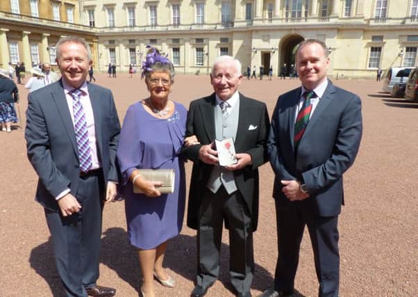 Roy Harrison at Buckingham Palace with his wife and sons. From left, Stephen Harrison, Muriel Harrison, Roy Harrison and Gareth Harrison.