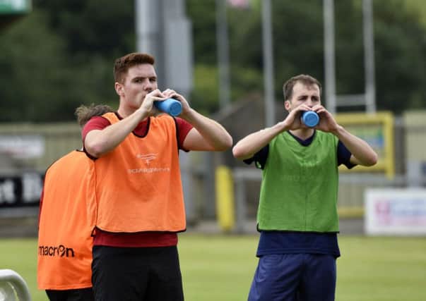Institute's new signings Sean McCarron and Stephen Curry (right) take a well earned drink during Saturday's pre-season session. inls2916-106km institute 6