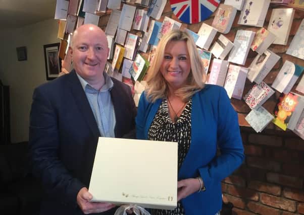 Jo-Anne Dobson and Steven Guy with a Memory Box, one of 300 produced every year in the Portadown office. INPT28-001