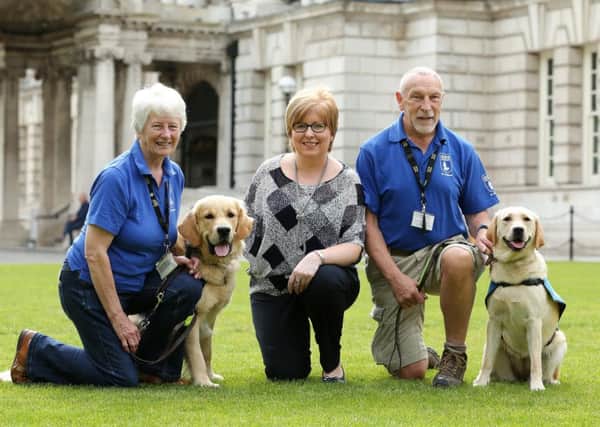 Sharon Wylie (centre) with pups in training Donald and Duffy and fellow Guide Dogs NI volunteers Winsome and Alan. INNT 29-804CON