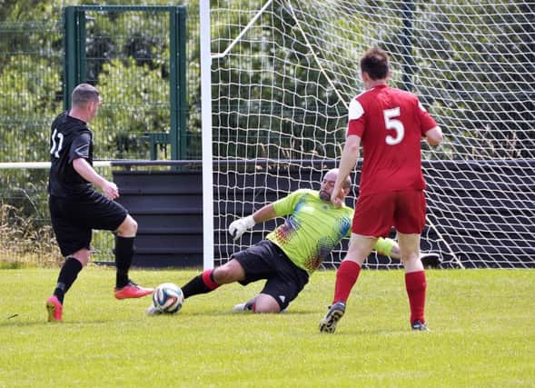 The goalkeeper get his toe to the ball just before the Distillery attacker as the hosts look to hold out. US2916-402PM Pics by Paul Murphy