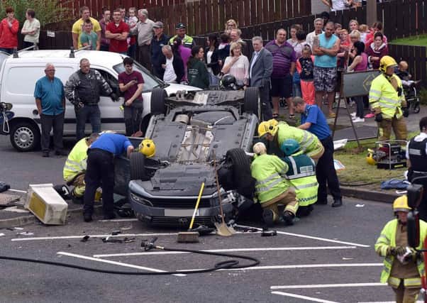 Emergency services attempt to free an occupant of a car which crashed on Garvaghy Road on Friday afternoon. INPT30-200.