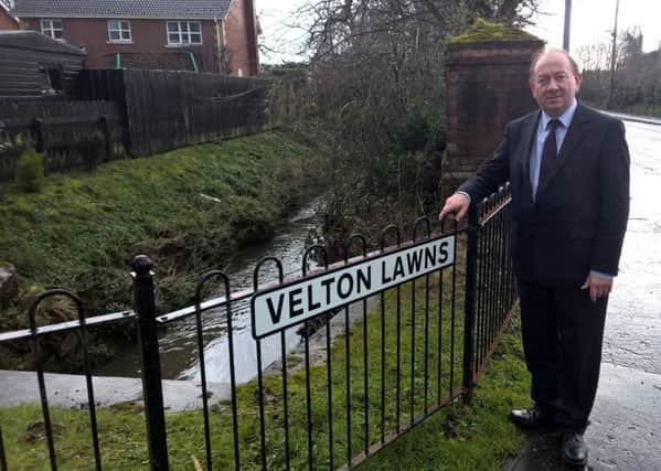 William Irwin MLA at the site where flood alleviation measures will be installed. INPT30-031