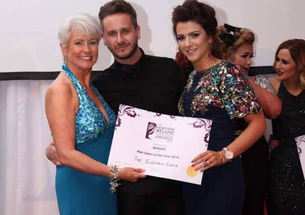 The Electric Chairs Tim Harrison and Megan McFerran receive the award for Hair Salon of the Year (County Antrim) from Pamela Ballentine.
