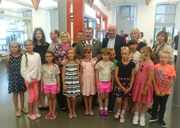 Mayor John Scott, Mayoress Audrey Scott and Councillor John Blair with representatives of the Newtownabbey branch of the Chernobyl Children's Appeal and children from Belarus who paid a visit to Mossley Mill last week. INNT 30-501CON