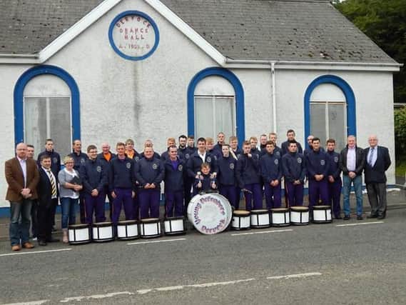 Twelve hours after having their bus and instruments decimated by a malicious fire, Dervock Young Defenders are pictured preparing to travel to a parade in Ballyclare. Included in the photo are Cllr William Blair, Cllr Sharon McKillop Cllr Darryl Wilson, Robin Swann MLA and Cllr Russell Watton showing their support.