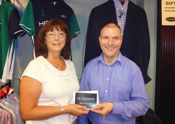 Muriel Gamble, secretary manager at Lurgan Golf Club receiving sponsorship from Stephen MacFarlane of J R McMahon Menswear, Lurgan.