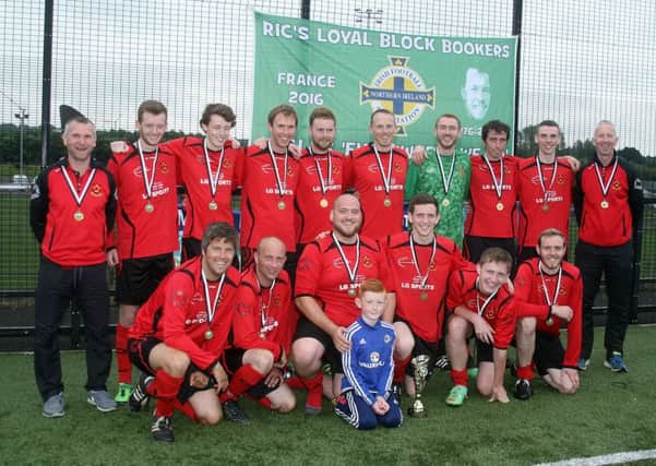 The victorious Ahoghill Rovers team with their medals and the Ric Moore Memorial trophy.