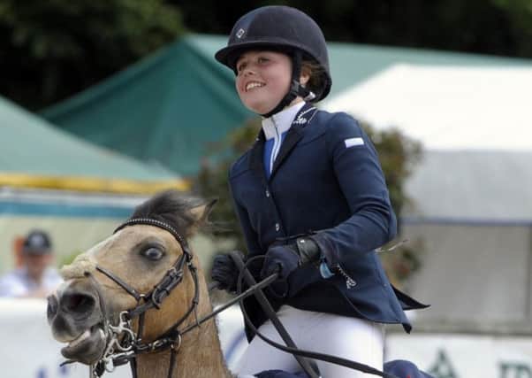 Banbridge girl Alex Finney  and Some Journey celebrate winning the Class 112 B 128 Ponies at the Dublin Horse Show. INBL1630-226PB