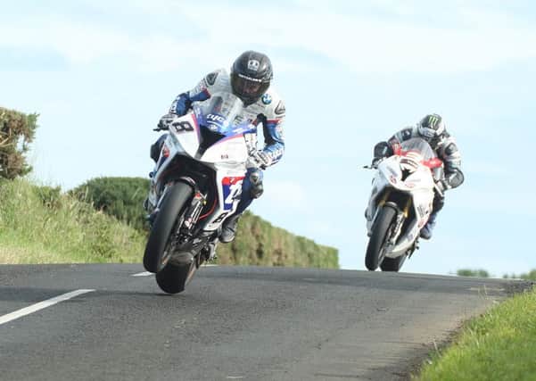 Guy Martin leads Michael Dunlop at last years Armoy races. Martin will be absent this year but Dunlop has confirmed his attendance. Picture: Roy Adams.