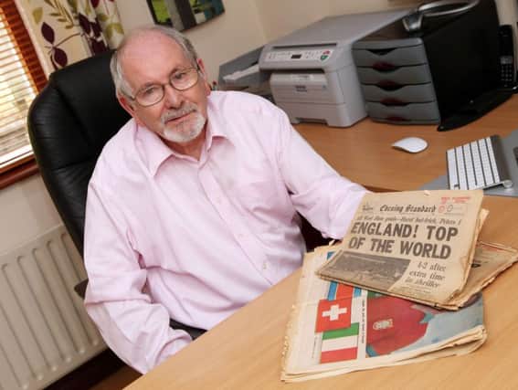 Jim White pictured with the newspapers from 1966.