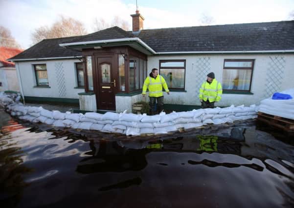 Gerry Hagan (left) from the Rivers Agency chats with Jimmy Quinn from Derrytresk, near Dungannon, who is among those affected by the rising water levels in Lough Neagh. PRESS ASSOCIATION Photo. Picture date: Thursday January 7, 2016. See PA story ULSTER Floods. Photo credit should read: Niall Carson/PA Wire