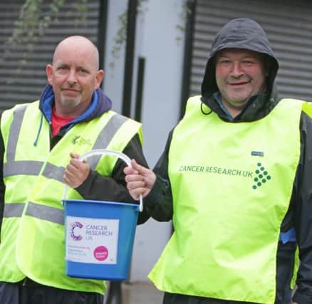 COLLECT. Doing their bit to raise funds for Cancer Research UK during the annual Cancer parade in the town on Saturday night are Barry Tutty and Ivor Wallace.INBM32-14 051SC.