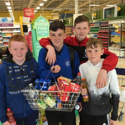 Carrickfergus College year 10 pupils, Lewis Peoples, Jack Lyttle, Jack Patterson and Jamie Lennon visited Tesco to hand over food they had collected for the Carrickfergus Foodbank and to donate a sum of money they had raised. INCT 31-704-CON