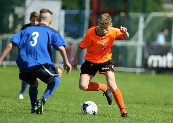 Jack Adamson (right) on the attack for County Armagh's junior squad in the SuperCupNI Globe final against County Down. Pic by PressEye Ltd.