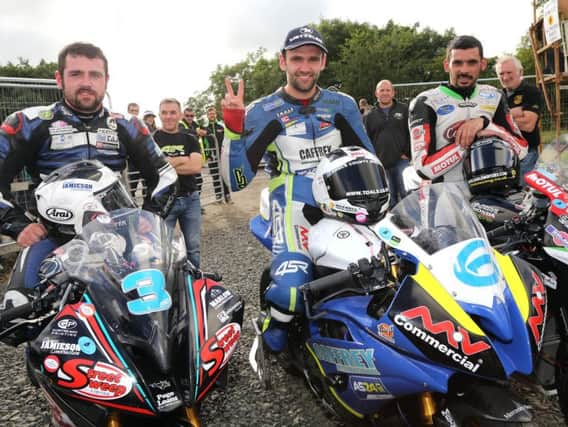 William Dunlop (centre) celebrates his win in the opening Supersport race at Armoy with runner-up Michael Dunlop (left) and Derek Sheils.