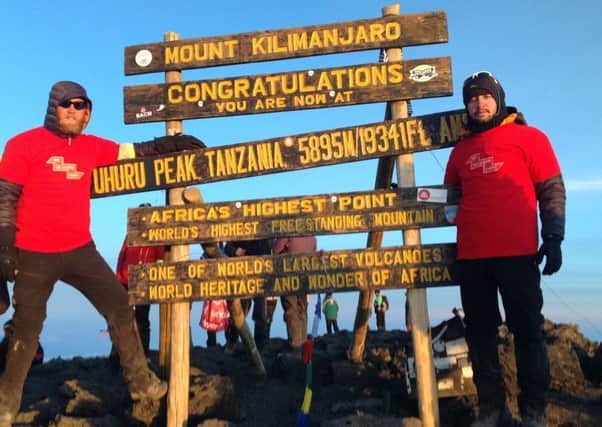 Barney (left) on top of Mount Kilimanjaro