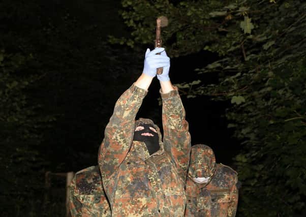 A masked and armed member of the republican dissident group Oglaigh na h-Eireann