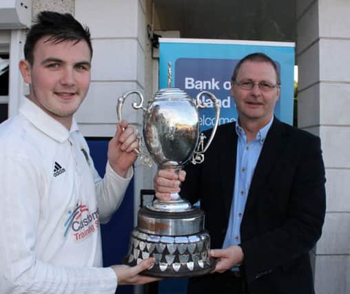 Donemana captain Ricky-Lee Dougherty gets the Bank of Ireland North West Senior Cup from Ian Stone of the Bank of Ireland. INLS39-NW Senior 1