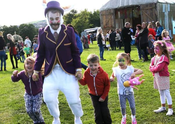 The Mad Hatter does some 'hopping' with the children during last year's Carnival of Colours. INLS3415MC029