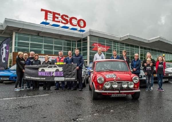 Staff at Tesco, Bentrim Road, Lisburn who are motoring ahead with a charity fundraiser in memory of car enthuiast and colleague Kris Niblock.