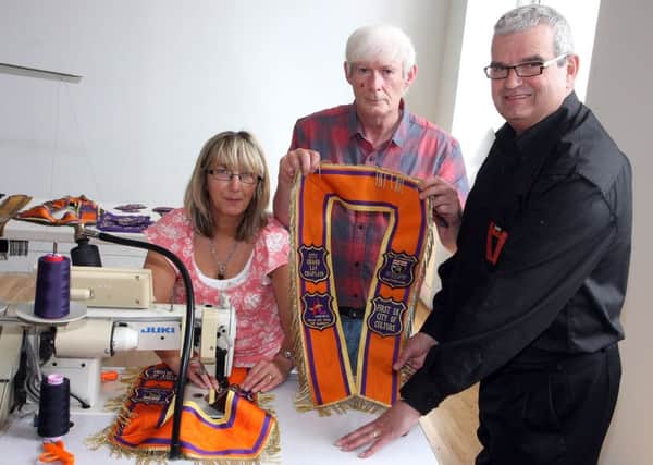 Victor Wray (right), PRO for the City Grand Orange Lodge,  with Mr and Mrs Ann and Wilson Sherrard, making UK City of Culture collarettes in 2013. INLS 1324-502MT.