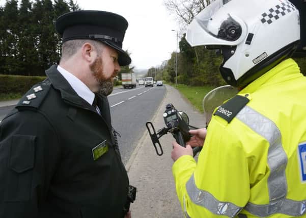 Inspector Declan McGrath, Local Neighbourhood Policing, chats to a PSNI Traffic Branch officer at Glenshane Road. INLS1515-190KM
