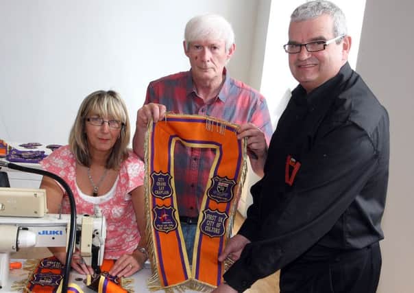 Victor Wray (right), PRO for the City Grand Orange Lodge,  with Mr and Mrs Ann and Wilson Sherrard, making UK City of Culture collarettes at a City Grand Lodge workshop in the Playhouse. INLS 1324-502MT.