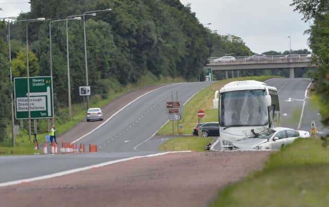 The scene after a woman in her 60s died in a collision between a car and a coach  on the A1 near Hillsborough on Friday morning. Pic Colm Lenaghan/Pacemaker